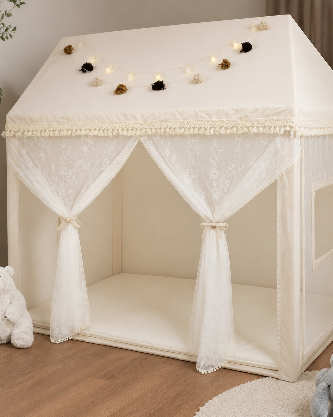 Close-up of the draped fabric and pom-pom garland on the Cloud Palace Canopy