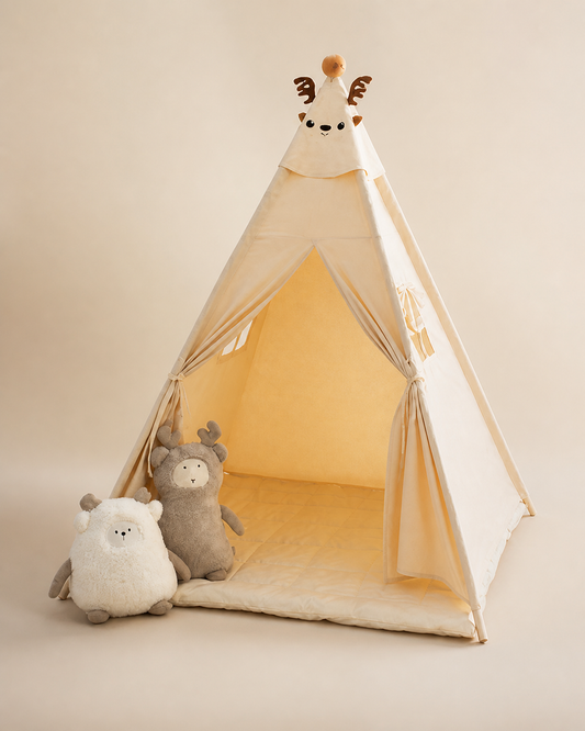 Cream kids teepee tent with a plush animal topper on a warm studio background