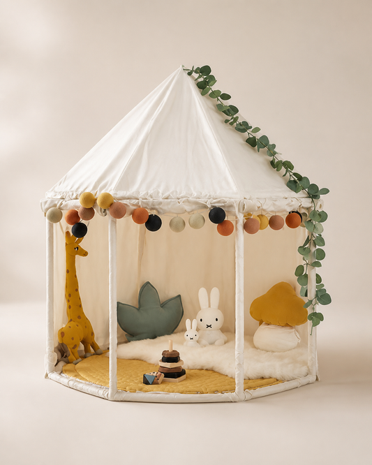 White round kids reading tent with garland trim on a warm studio background